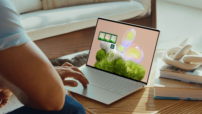 Angled white Dell XPS 13 laptop on a table.