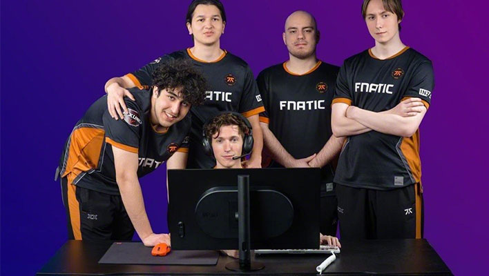 Fnatic team standing around Sony's INZONE monitor.
