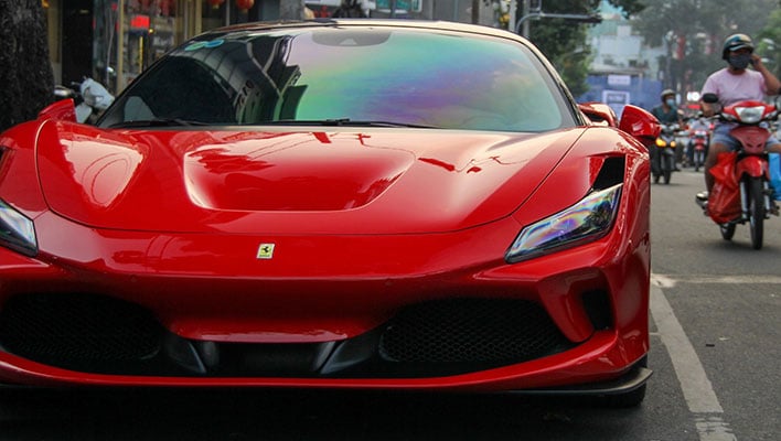 Front shot of a red Ferrari on a road.