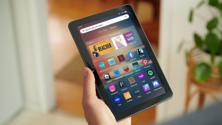 Hand holding an Amazon Fire HD 8 tablet.