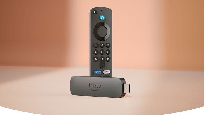 Amazon Fire TV Stick with remote in front of a pinkish background.