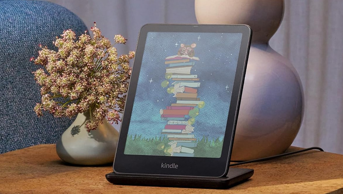 Kindle Colorsoft on a wireless charger on a nightstand.