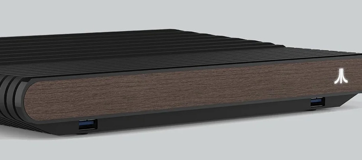 Angled closeup of the Atari VCS with a walnut finish on the front.