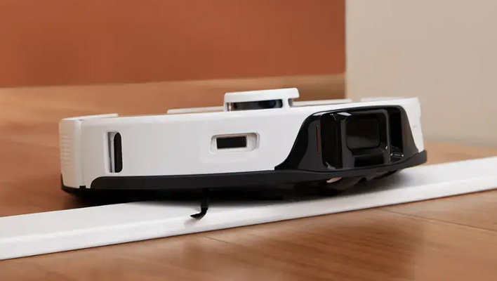 Roborock S8 Ultra robot vacuum going over a bump in the floor.