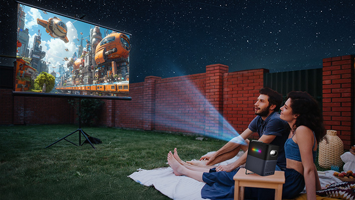 TCL Projector A1 beaming an image outside under a starry sky.
