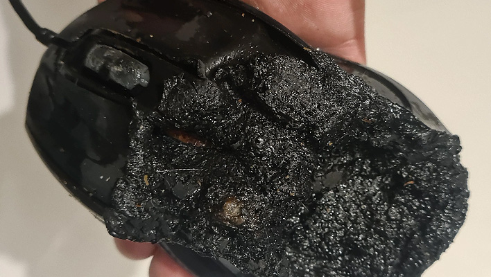 Closeup of a Gigabyte mouse that is burned and melted.