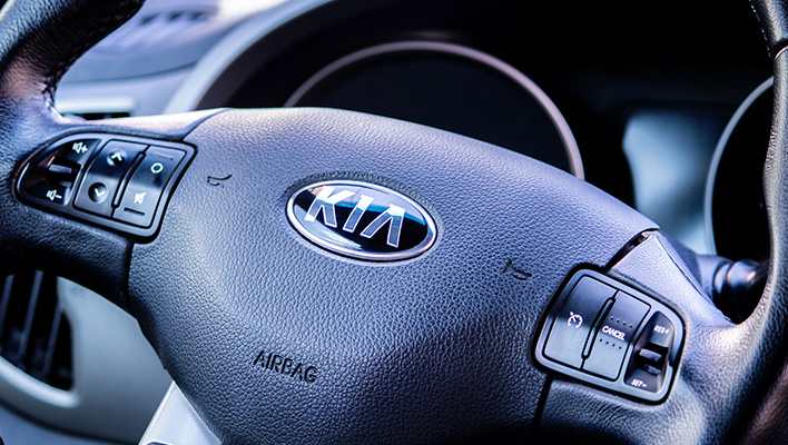 Close up of a Kia steering wheel.