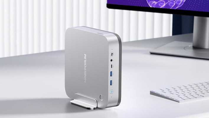 Minisforum AI X1 Pro mini PC in a dock on a desk.