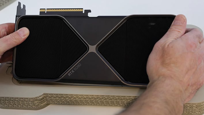 Holding a GeForce RTX 5090.