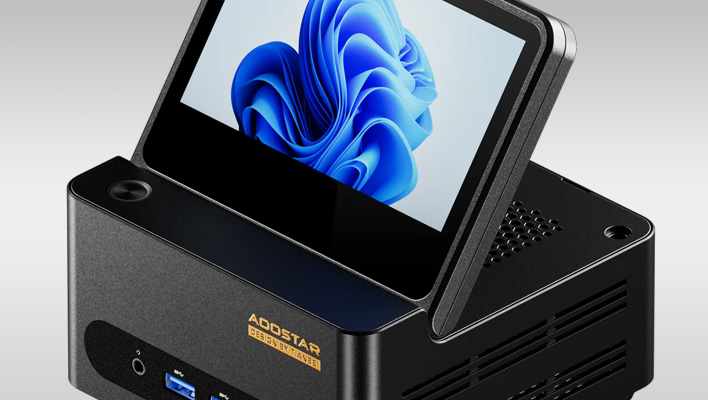 Closeup render of an Aoostar mini PC with a flip-up display, on a gray gradient background.