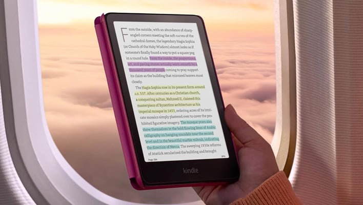 Holding a Kindle Colorsoft in front of an airplane window.