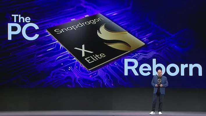 Qualcomm president and CEO Cristiano Amon on stage in front of a Snapdragon X Elite graphic that reads, "The PC reborn."