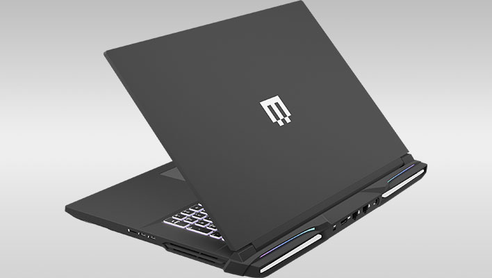 Rear angled view of Maingear's Ultima 18 gaming laptop on a gray gradient background.