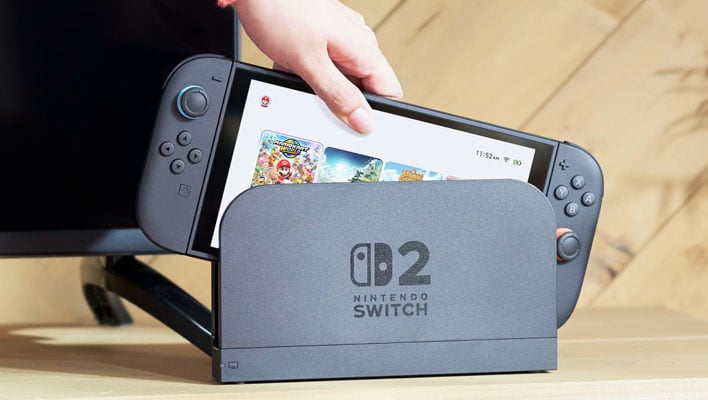 Nintendo Switch 2 being pulled out of a dock.