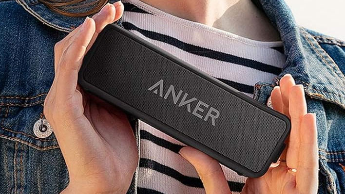 Hands holding the Anker Soundcore 2 speaker.