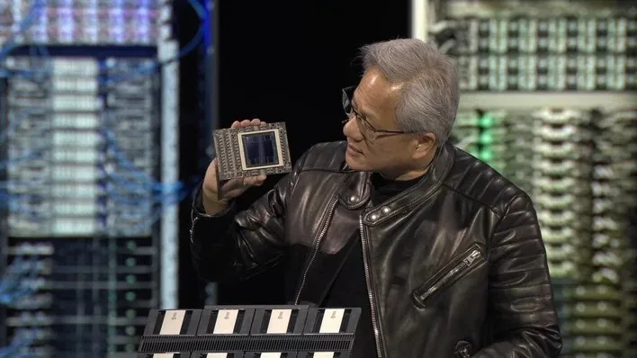 NVIDIA CEO Jensen Huang holding a chip.