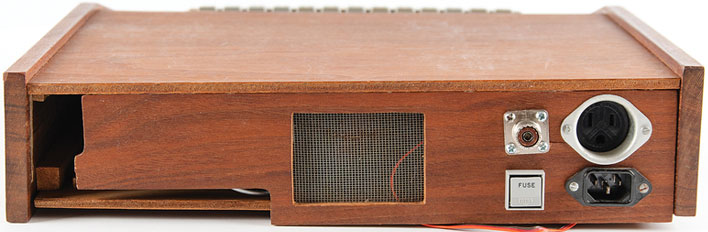 Rear view of an Apple-1 inside a wooden Byte Shop case.