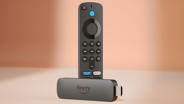 Amazon Fire TV Stick with remote on a peach colored background.