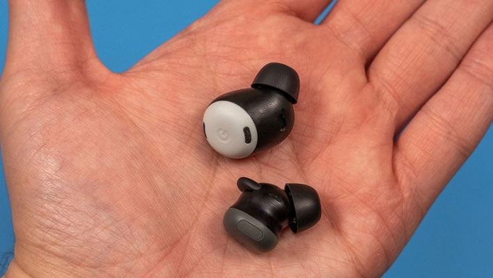 Google Pixel Buds Pro 2 in a hand, in front of a blue background.
