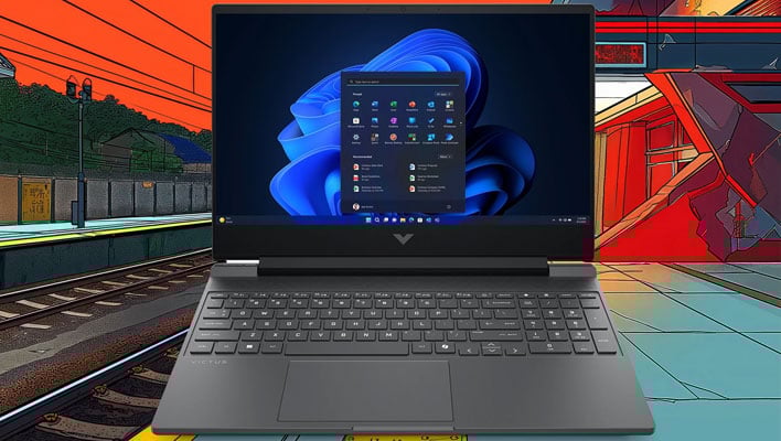HP Victus laptop in front of a cartoon image of a train track and station.