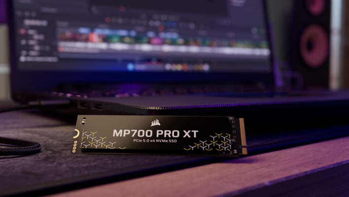 Corsair MP700 Pro XT SSD in front of a laptop.
