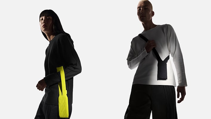 Man and woman wearing iPhone Pocket accessories.