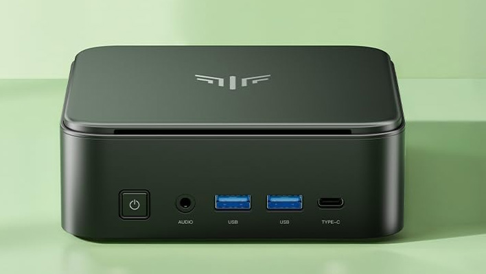 Kamrui mini PC (front shot on a green background).