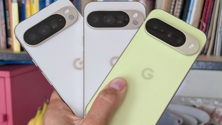 Holding three Pixel 10 phones.