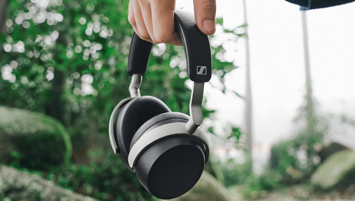 Hand holding Sennheiser's HDB 630 headphones. 