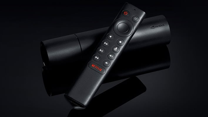 NVIDIA Shield TV with remote on a black background.