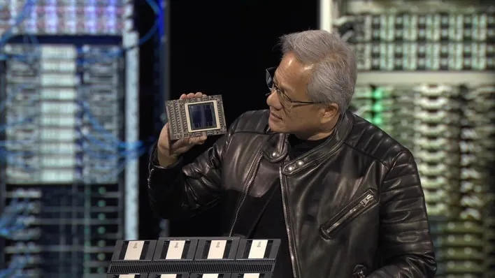 NVIDIA CEO Jensen Huang holding a Blackwell chip.