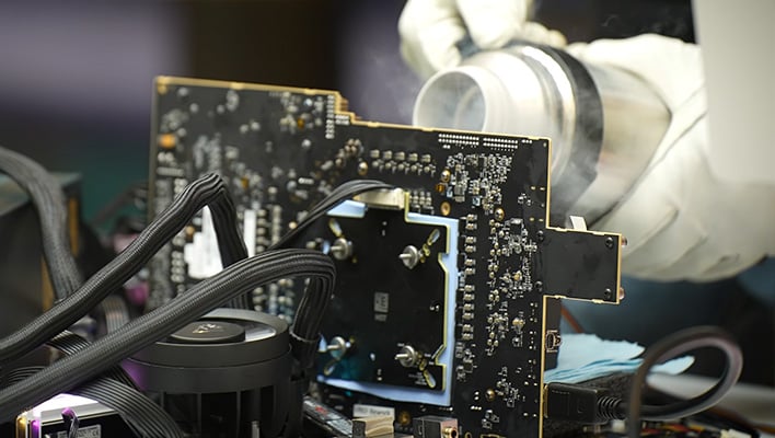 Liquid nitrogen being poured onto a Radeon RX 9060 XT.