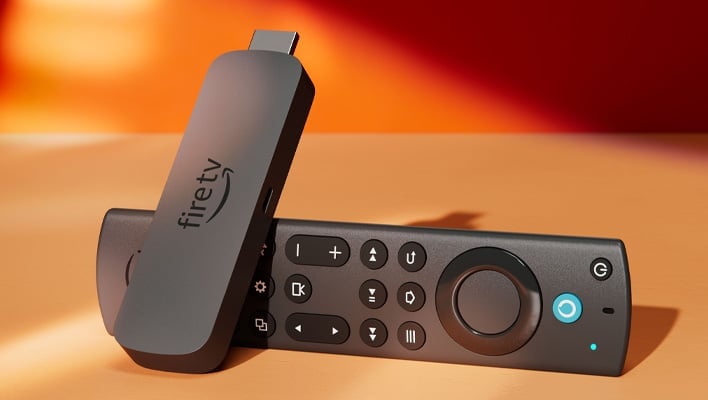 Amazon Fire TV Stick with remote on an orange background.
