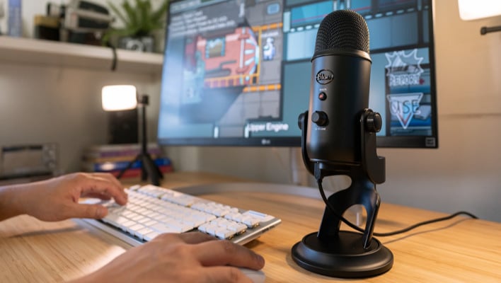 Logitech Blue Yeti USB microphone on a desk.