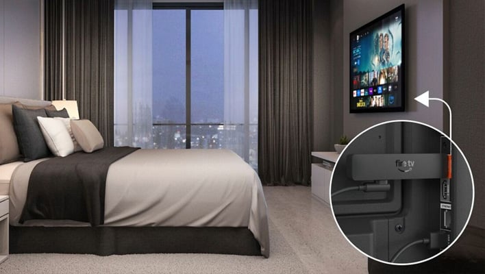 Amazon Fire Stick HD in a bedroom with a closeup of the Stick showing it using a USB cable.