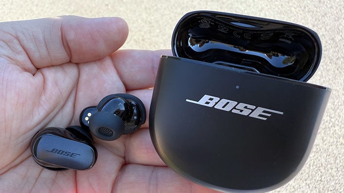 Bose QuietComfort Ultra Earbuds (2nd Gen) with case in a palm of a hand.