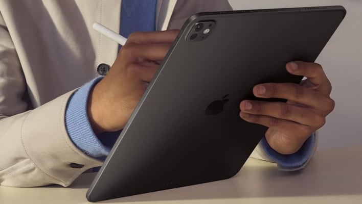 Person holding an iPad Pro.