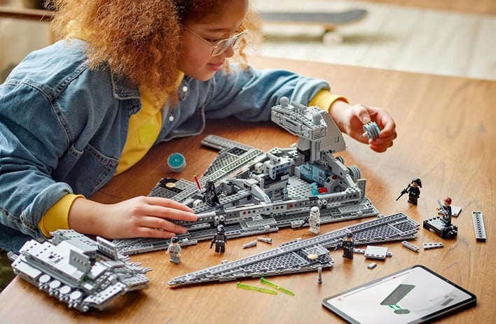 girl playing with lego star wars