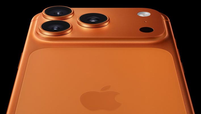 Closeup rear render of an orange iPhone 17 Pro on a black background.