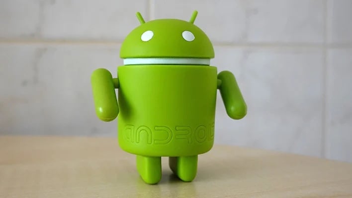android figuirine on table