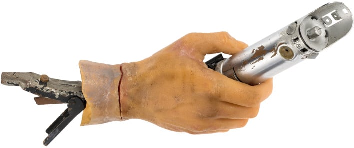 Star Wars lightsaber prop with severed hand.