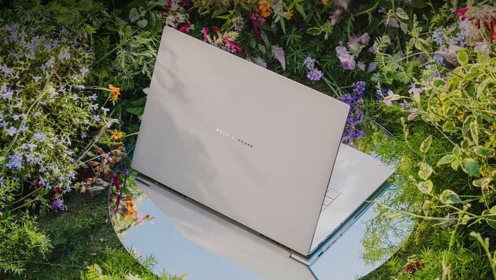 ASUS Zenbook 14 Air laptop in a field of flowers.