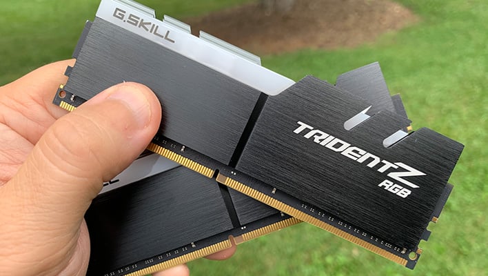 Holding a pair of G.Skill Trident Z RGB memory modules.