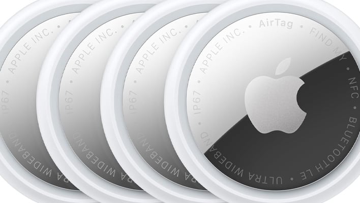 Row of four Apple AirTag 2 trackers.